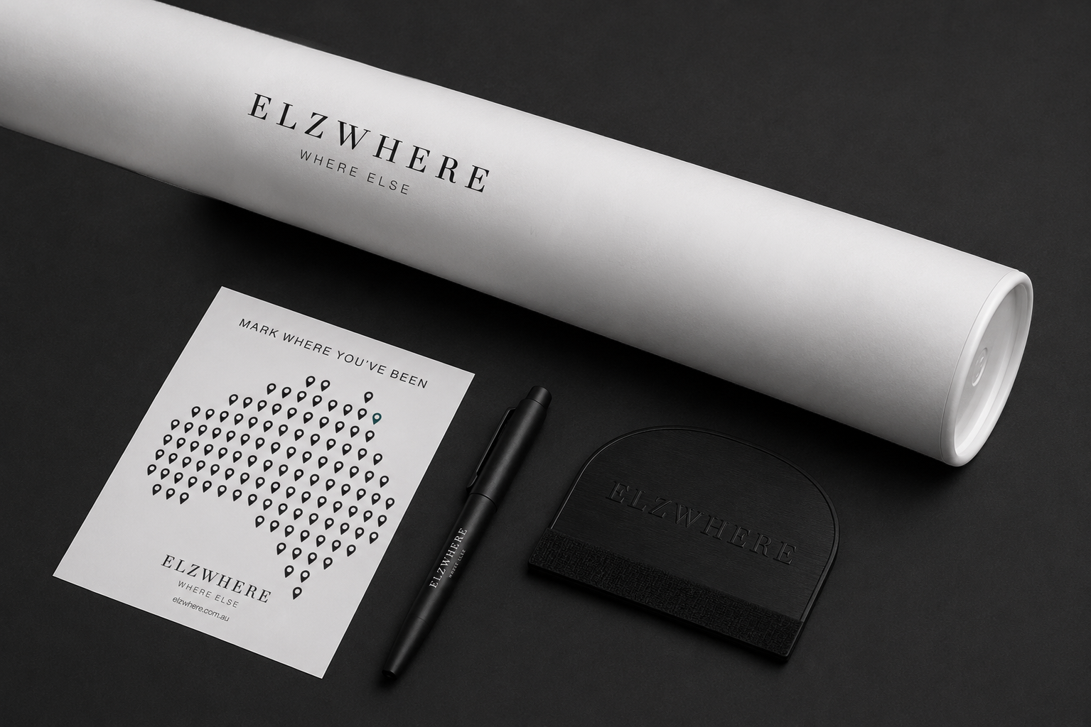 ELZWHERE Application Kit — white cylinder, location pin sticker sheet, squeegee and marker pen on black background